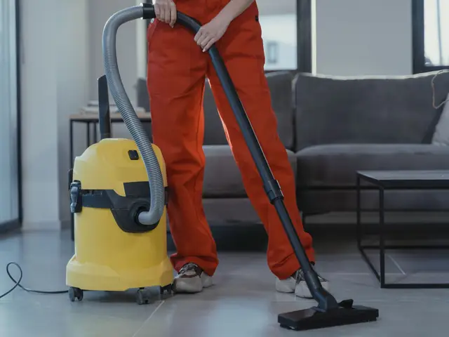 Cleaner vacuuming a living room